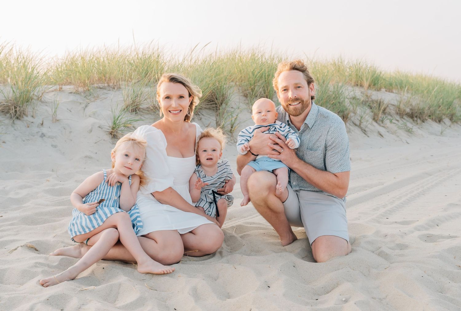 A family of five pose for a photo taken by Lauren Marie photography on the spring lake beach in Monmouth County NJ.