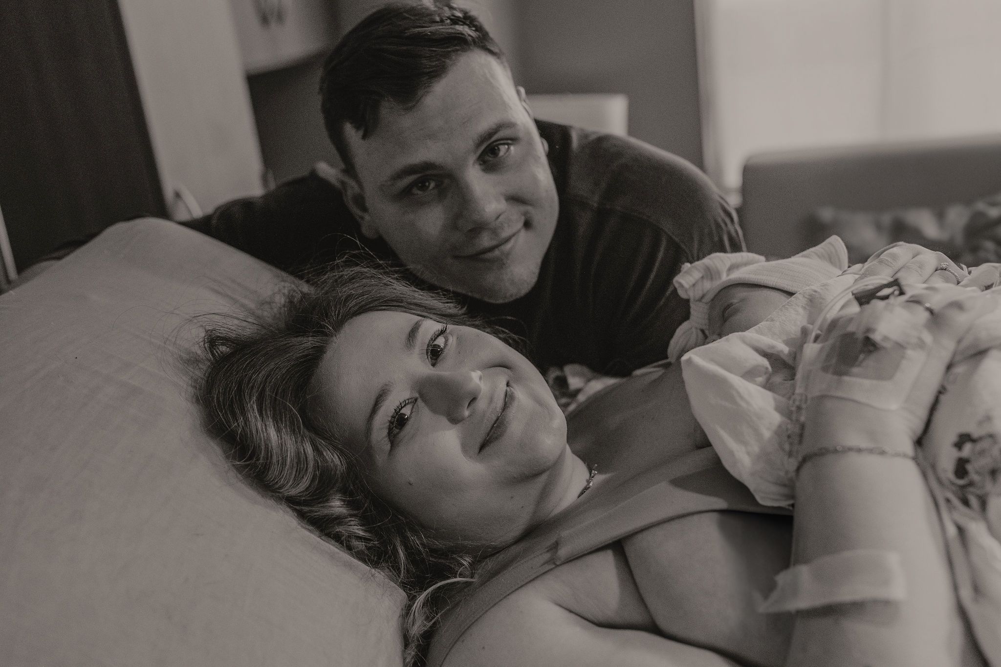 Black and white lifestyle photos capturing intimate family moments at home.