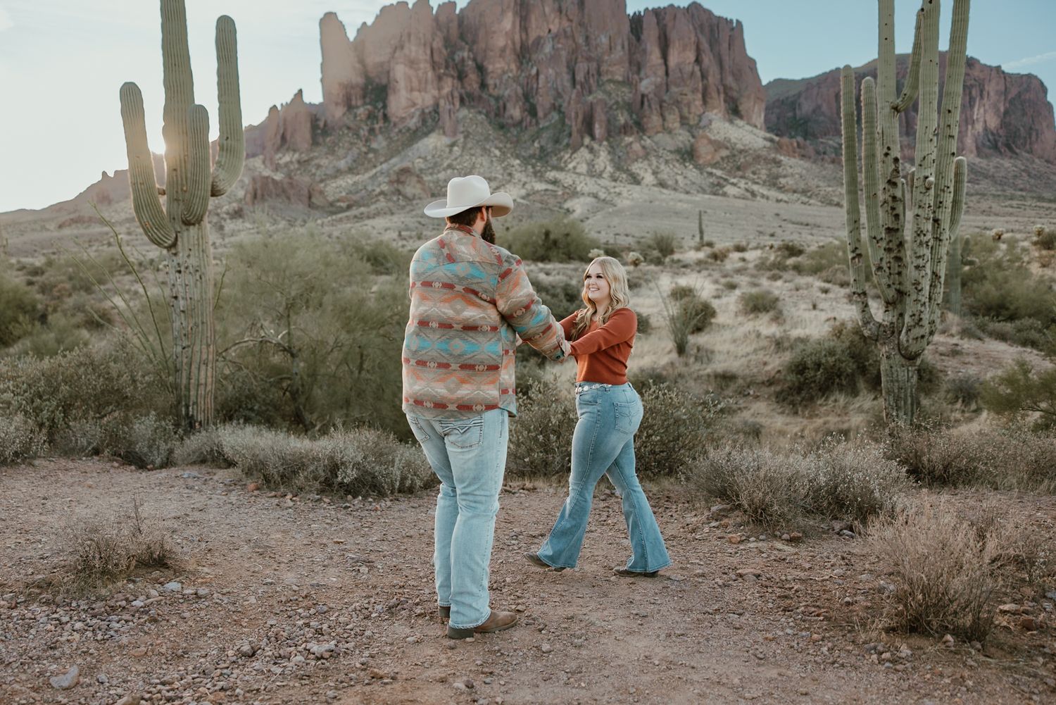 Joyfully dancing around the desert in front of ther Superstition Mountains.