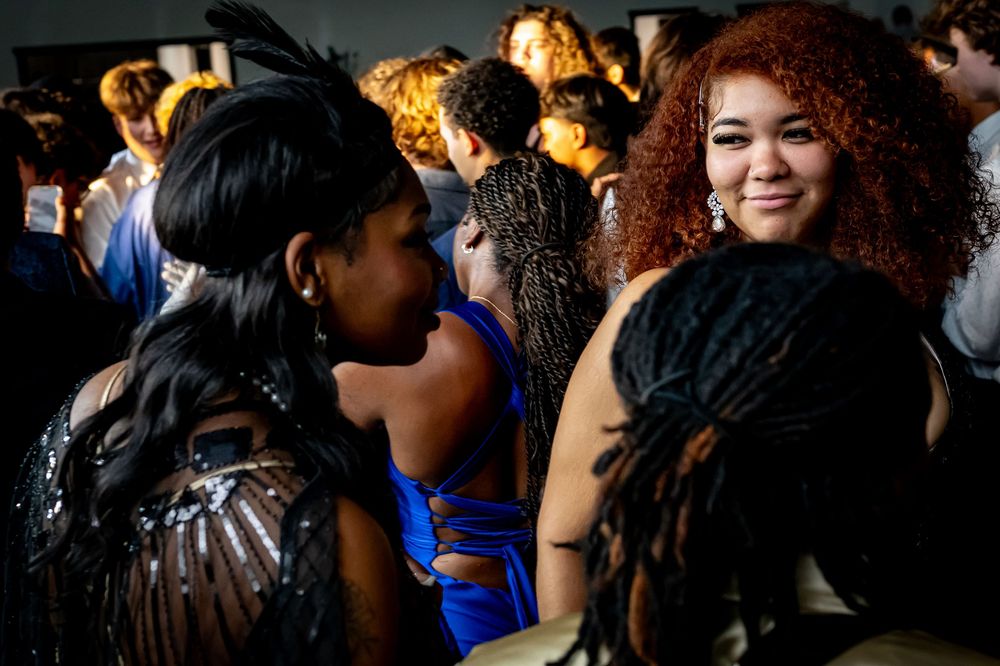Party guests enjoying themselves on a crowded dance floor at a formal event.