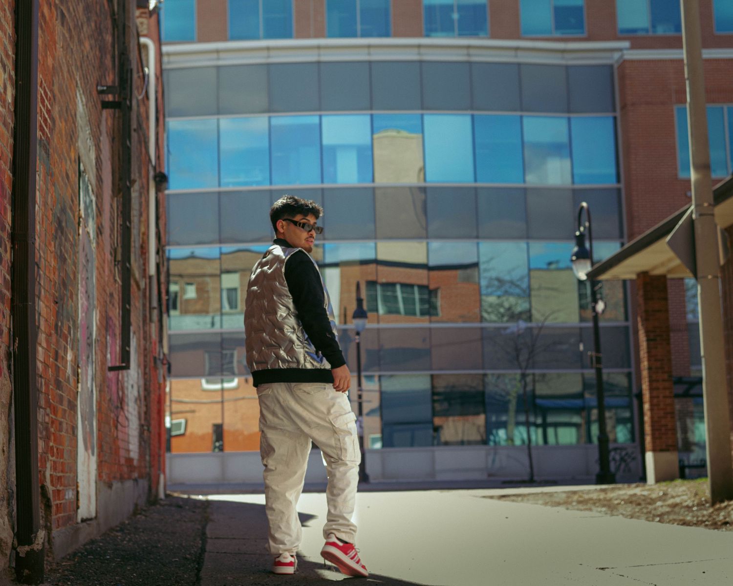 Wide angle shots of an urban setting with modern glass buildings and brick walls.