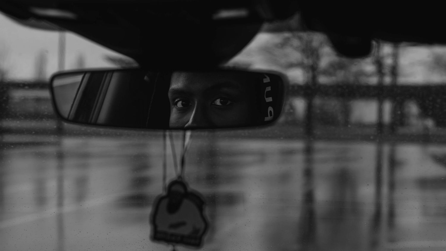 A series of dark silhouettes against a blurred background show someone sitting on a vehicle.