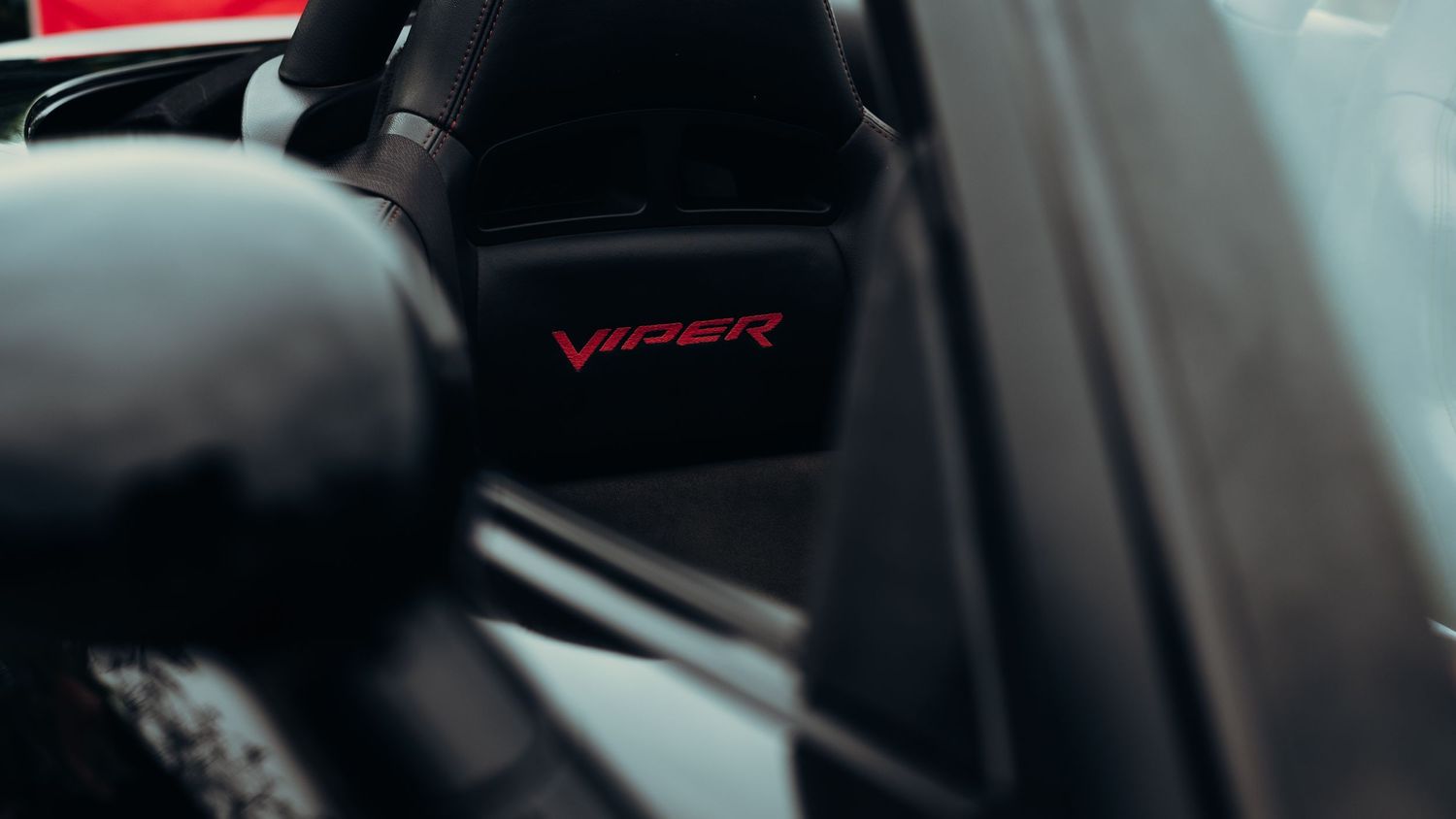 Close-up details of a red and black Viper sports car interior.