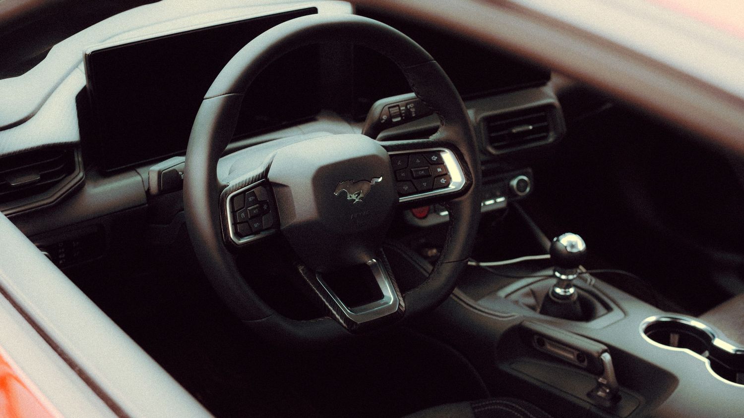 Modern car interior showing center console and gear shifter details.