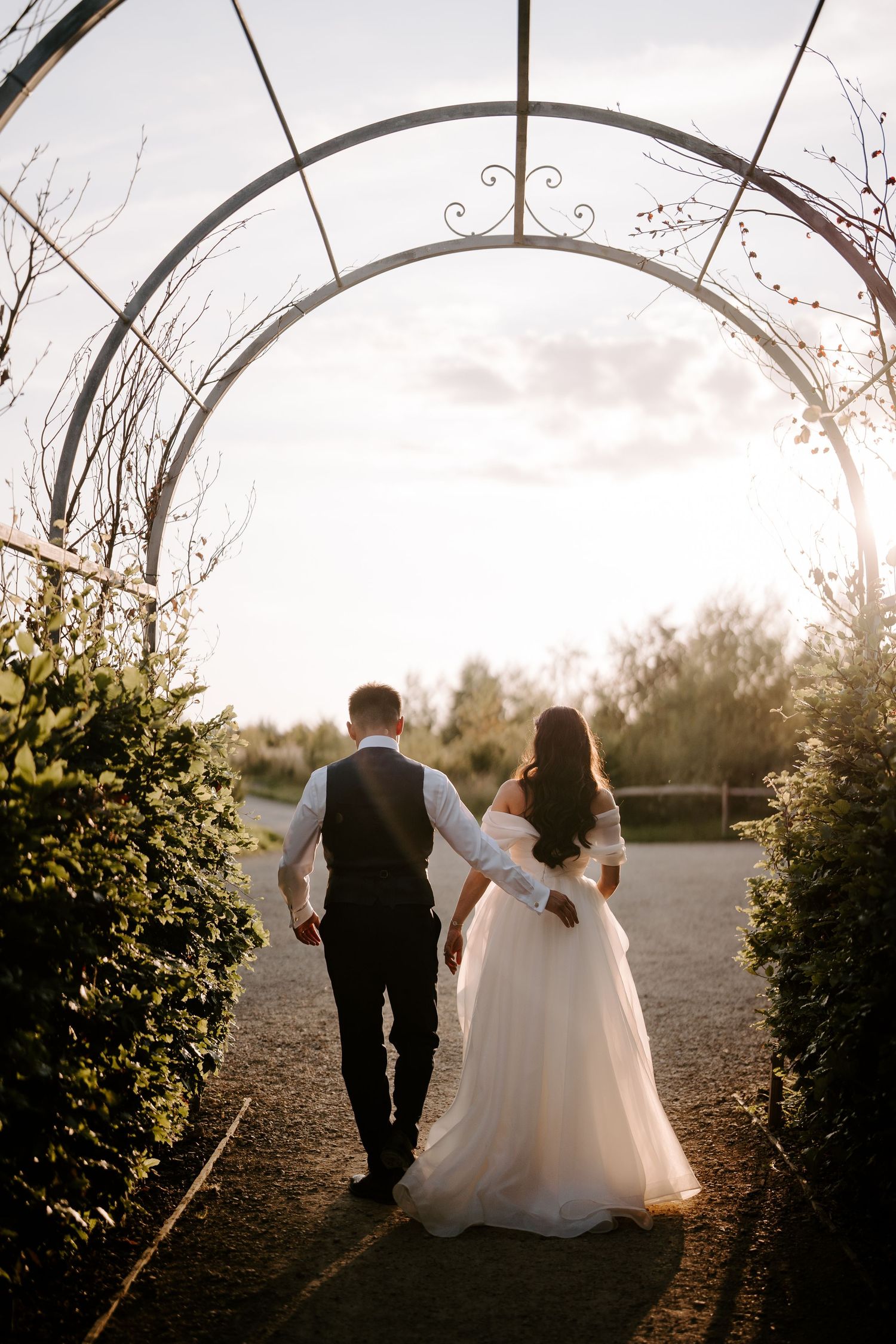 bride and groom walking into the sunset at yardspace old gore Cirencester