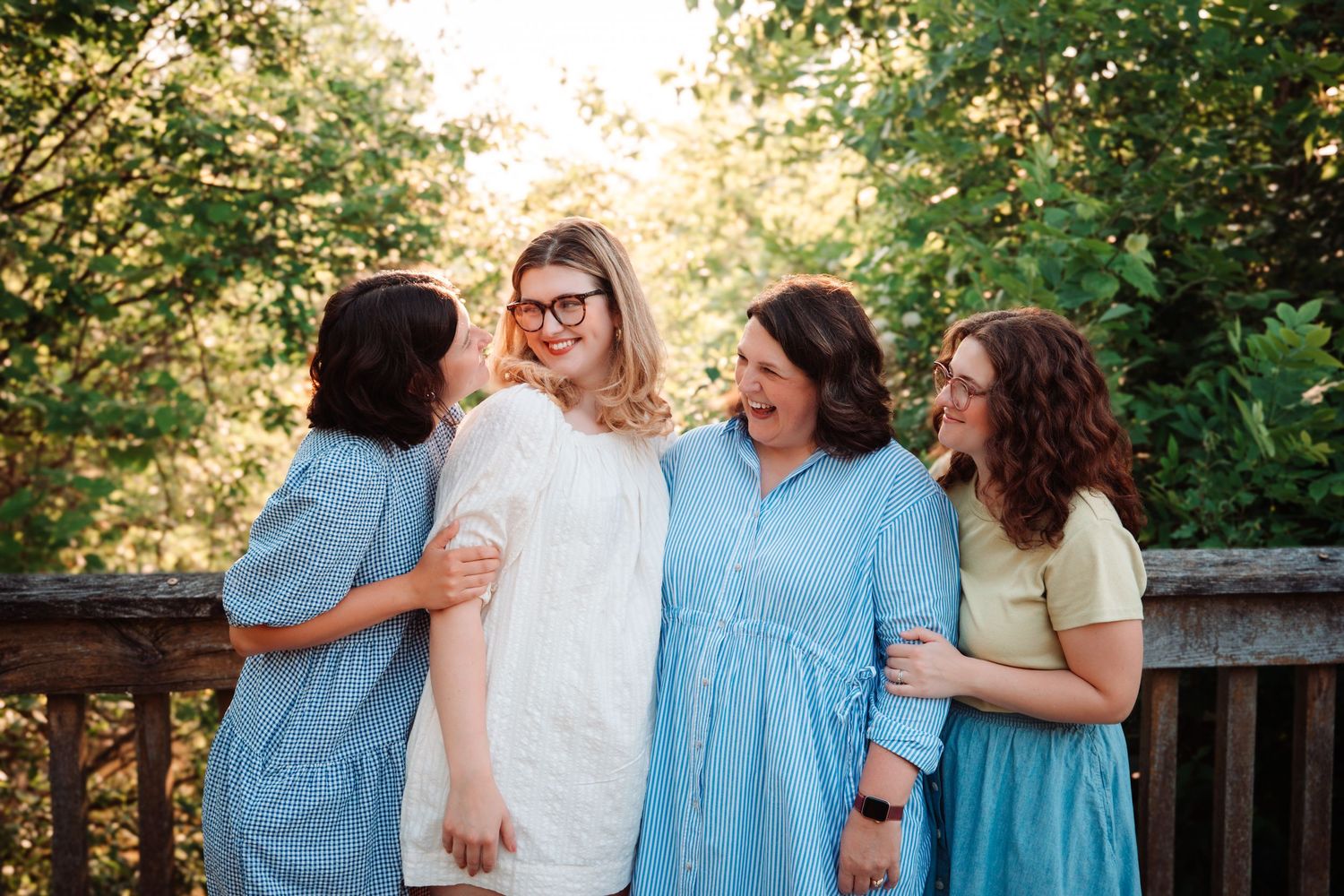 Family group photos in coordinated blue and pastel outfits during golden hour.
