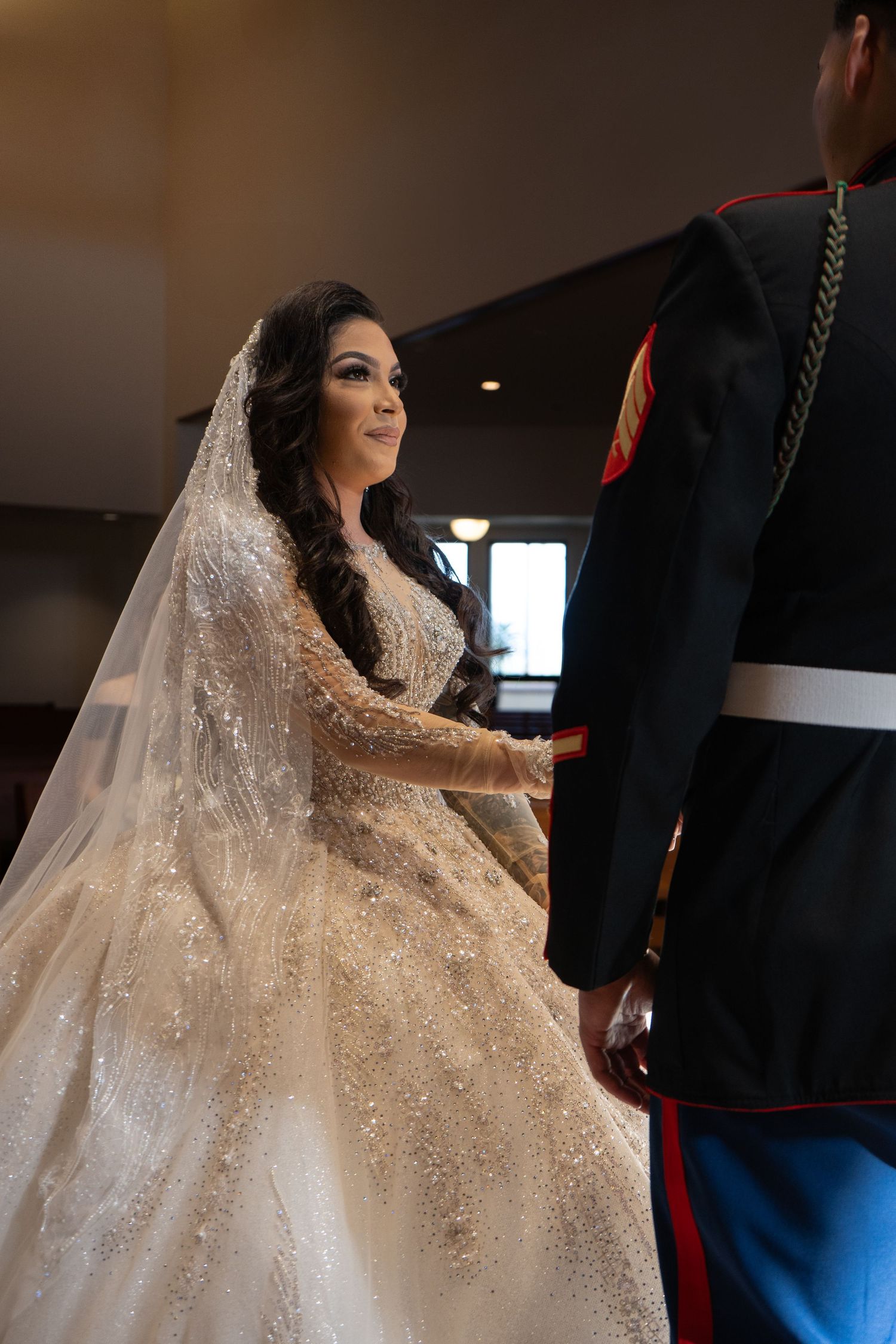 A sparkling white wedding dress with intricate beading and a flowing train.