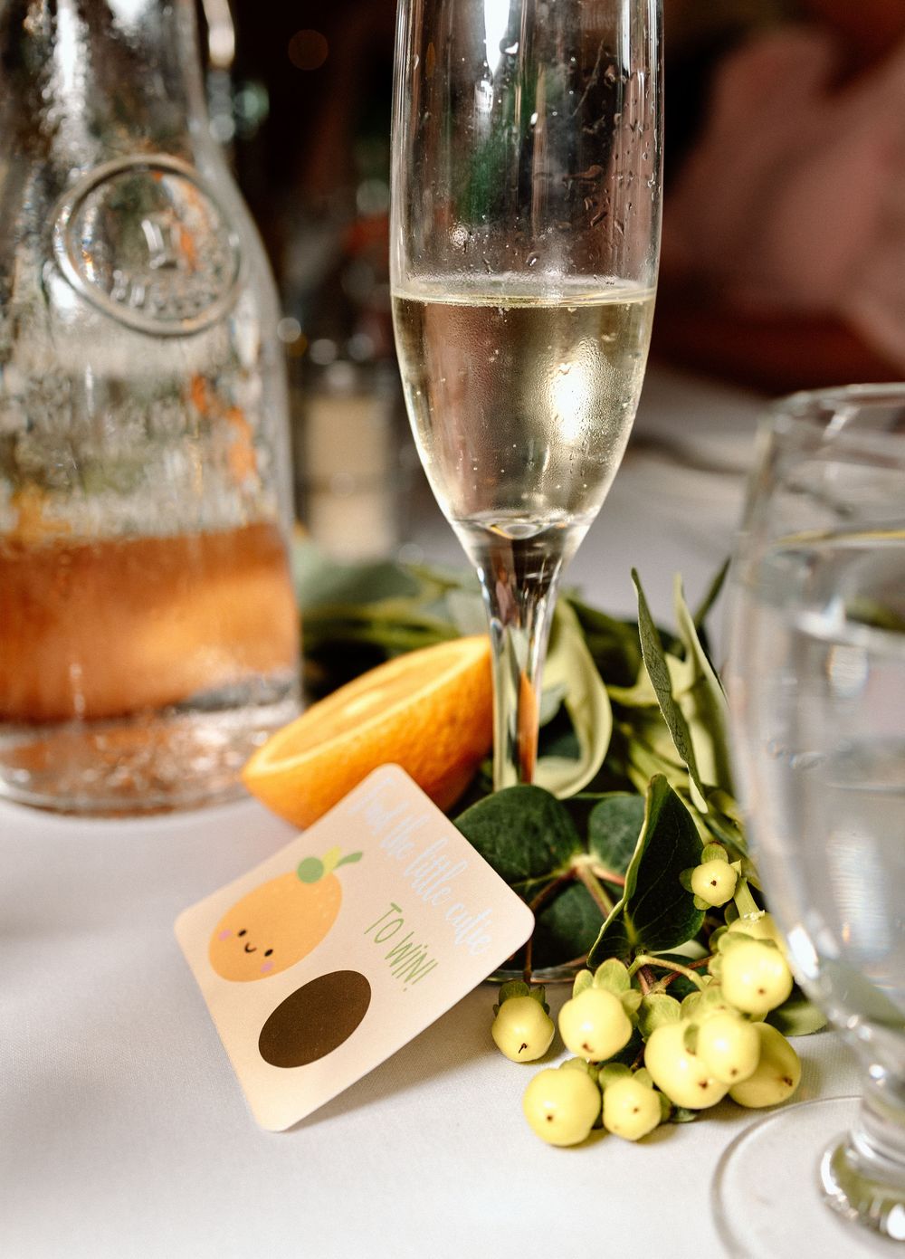 Champagne flutes and yellow floral arrangements on an elegant table setting.