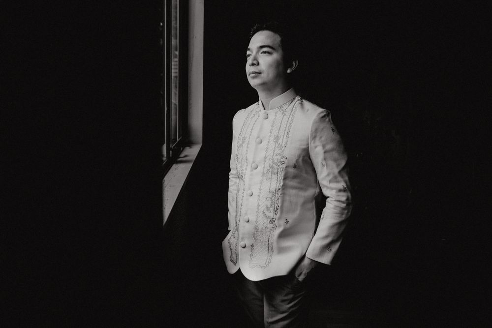 Classic Barong Tagalog attire shown in dramatic black and white lighting.