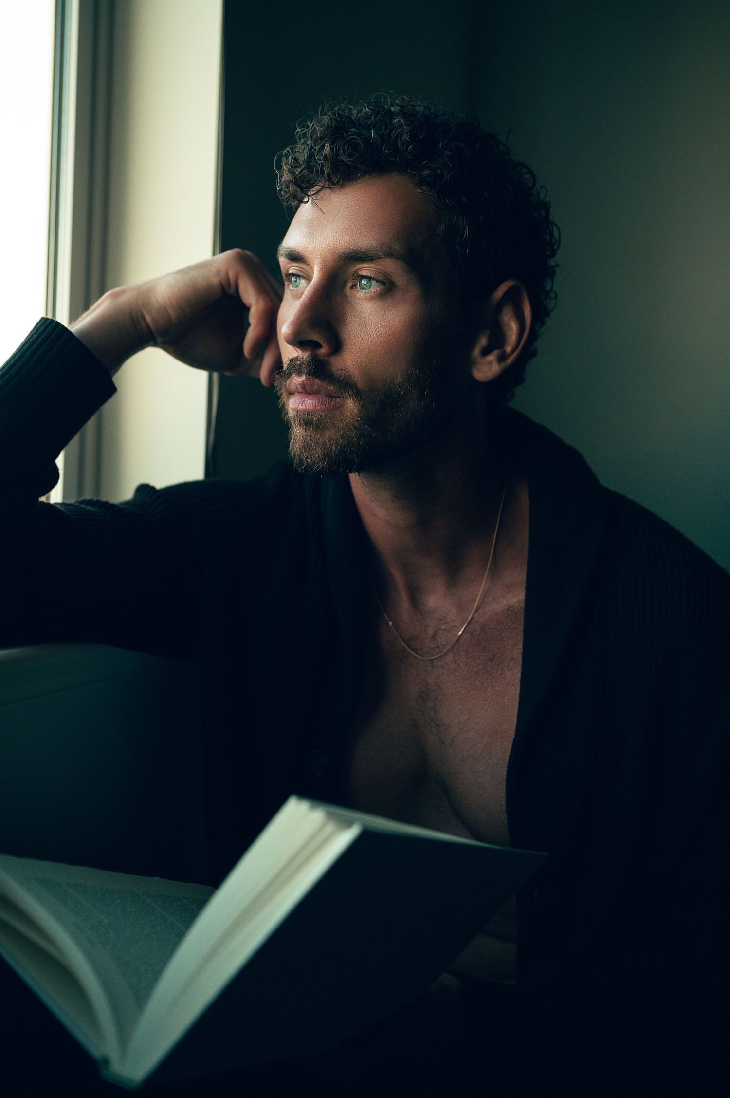 LGBTQ friendly photographer in Salt Lake City Utah. Male Self Portrait in studio by Carl James reading a book.