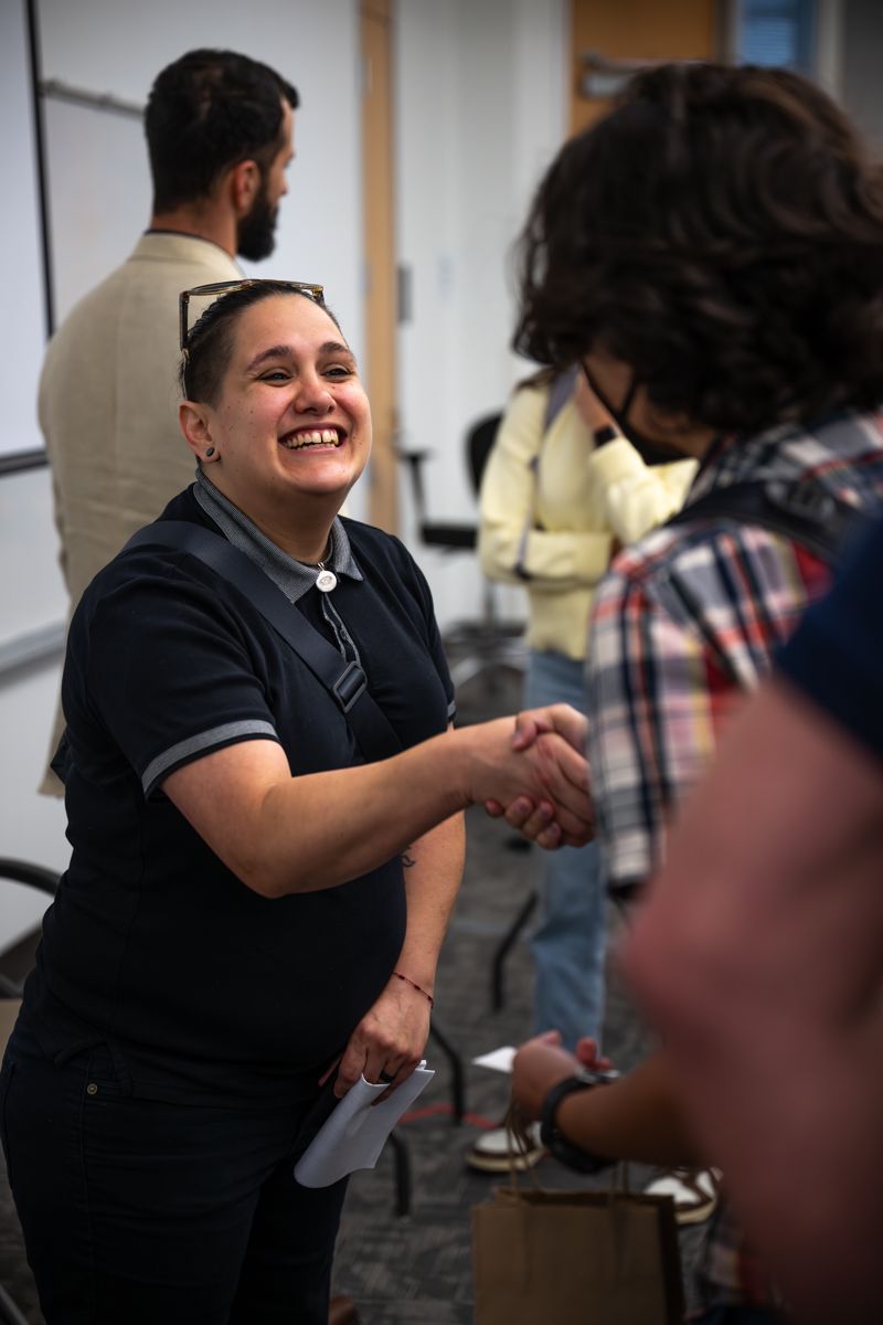 A series of professional handshakes and smiles during a business networking event in an office setting.