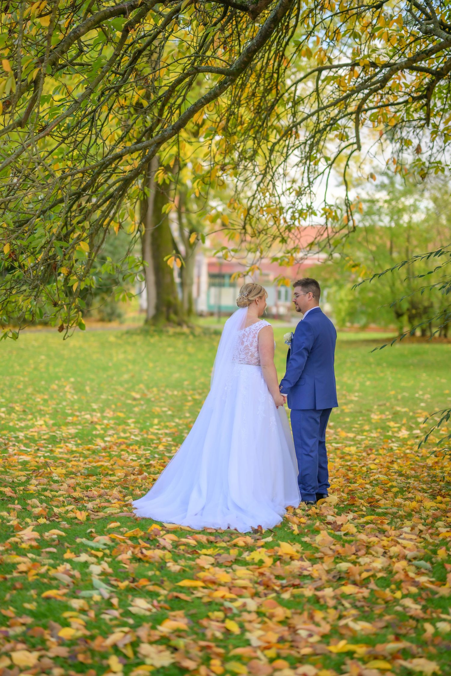 A romantic wedding couple poses in a series of elegant shots under stone archways at a historic European castle.