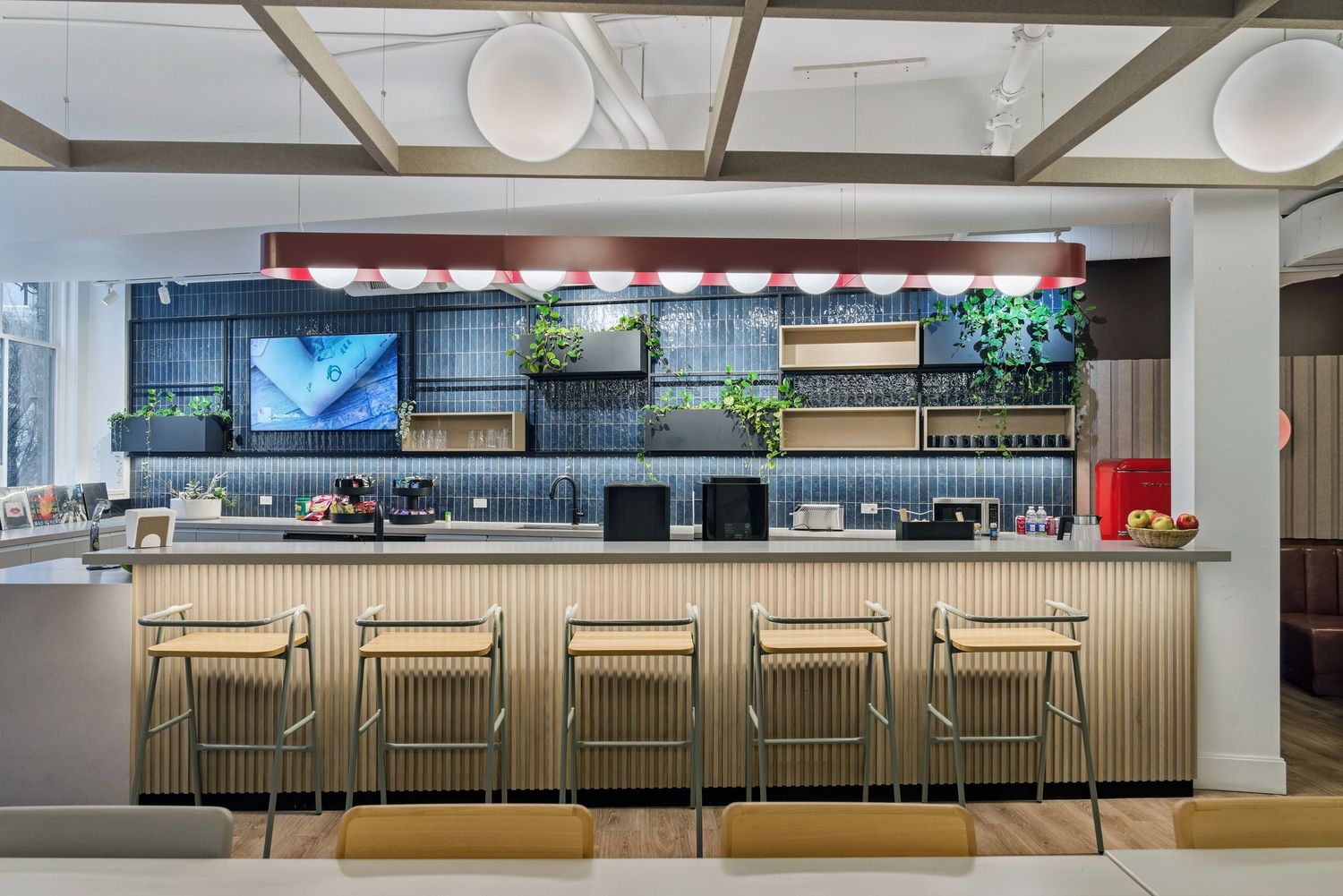 Modern bar counter with wooden stools and backlit panels creates an elegant hospitality setting.