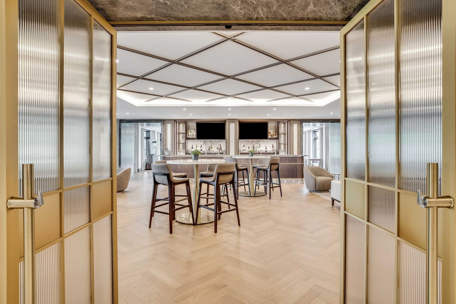 Modern office interior with wood flooring, glass partitions, and ceiling-mounted lighting in a panoramic view.