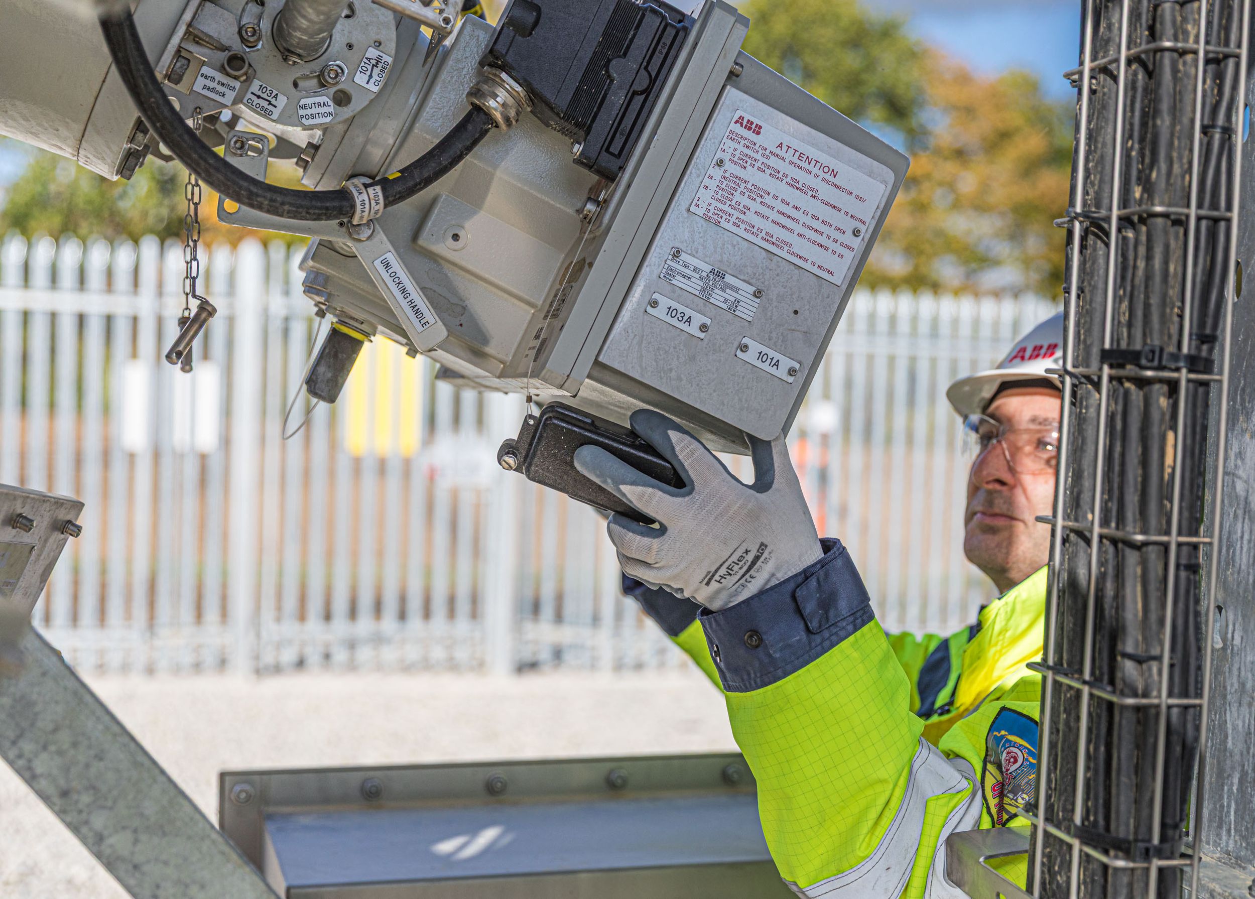 Site engineer in full PPE working on an ABB grid connection at a renewable energy facility -12