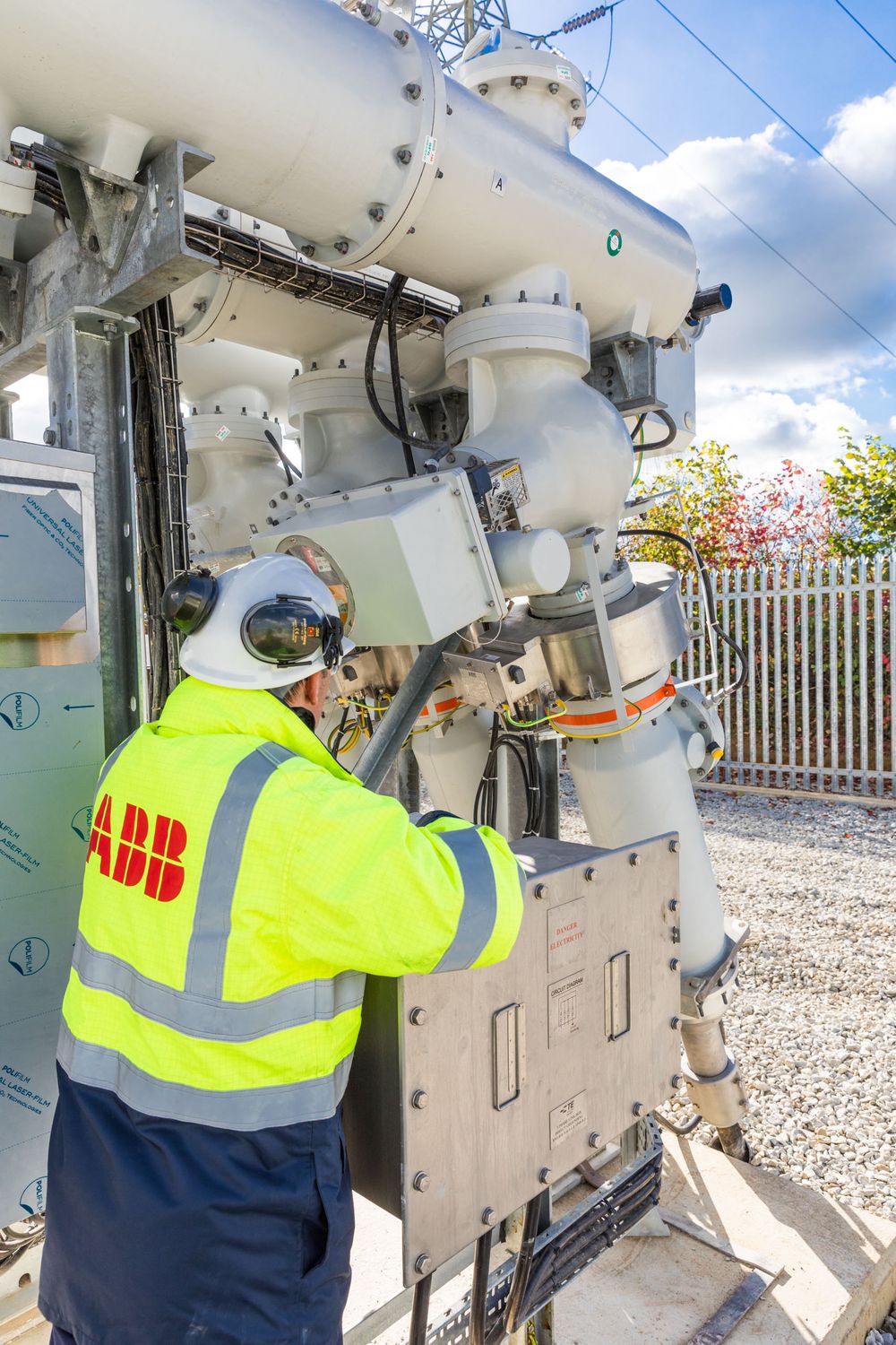 Site engineer in full PPE working on an ABB grid connection at a renewable energy facility -14