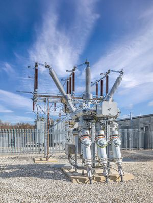 Site engineer in full PPE working on an ABB grid connection at a renewable energy facility -4