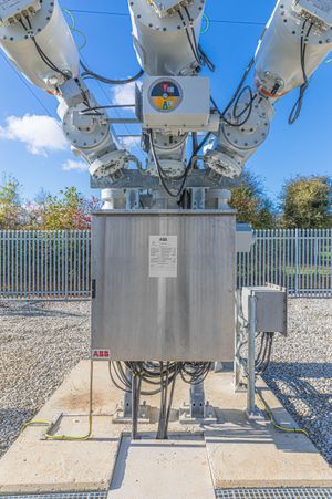 Site engineer in full PPE working on an ABB grid connection at a renewable energy facility -6
