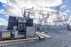 Site engineer in full PPE working on an ABB grid connection at a renewable energy facility -8