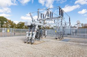 Site engineer in full PPE working on an ABB grid connection at a renewable energy facility -9