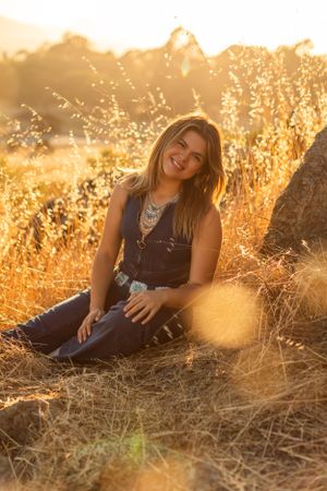 A golden hour portrait in tall grass capturing warm light and natural scenery.