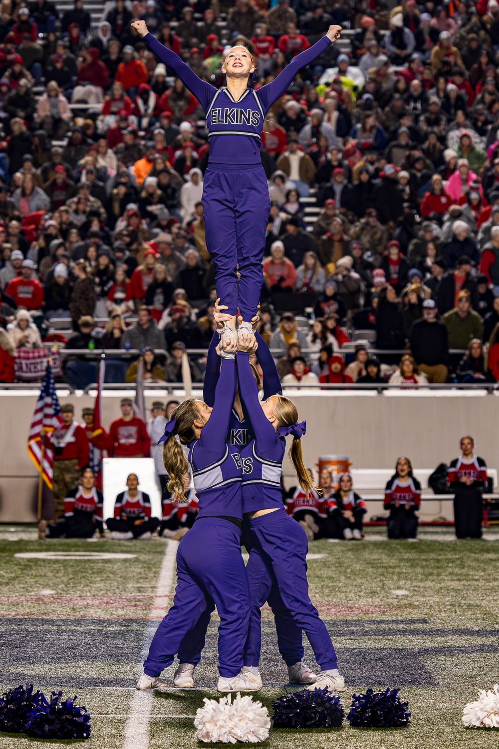 Elkins AR Cheerleaders in purple uniforms perform a dramatic lift stunt during the 4A Championship game at War Memorial vs Dardanelle