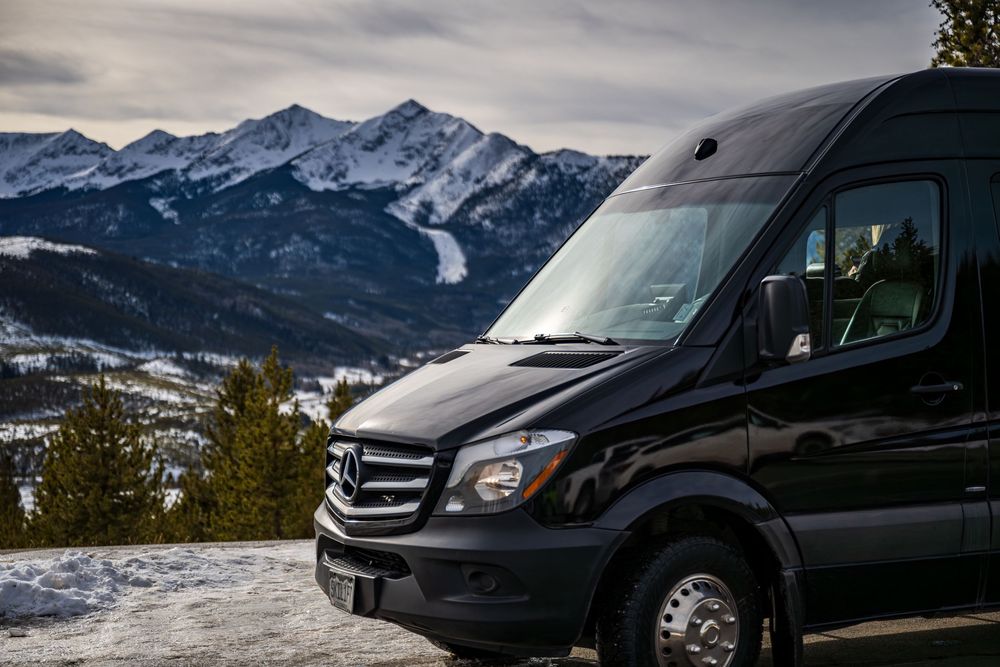 Shot of the Ski Lift Limo in front of mountain peaks by Denver Hospitality, Travel & Tourism photographer Captain Colorado Photography.