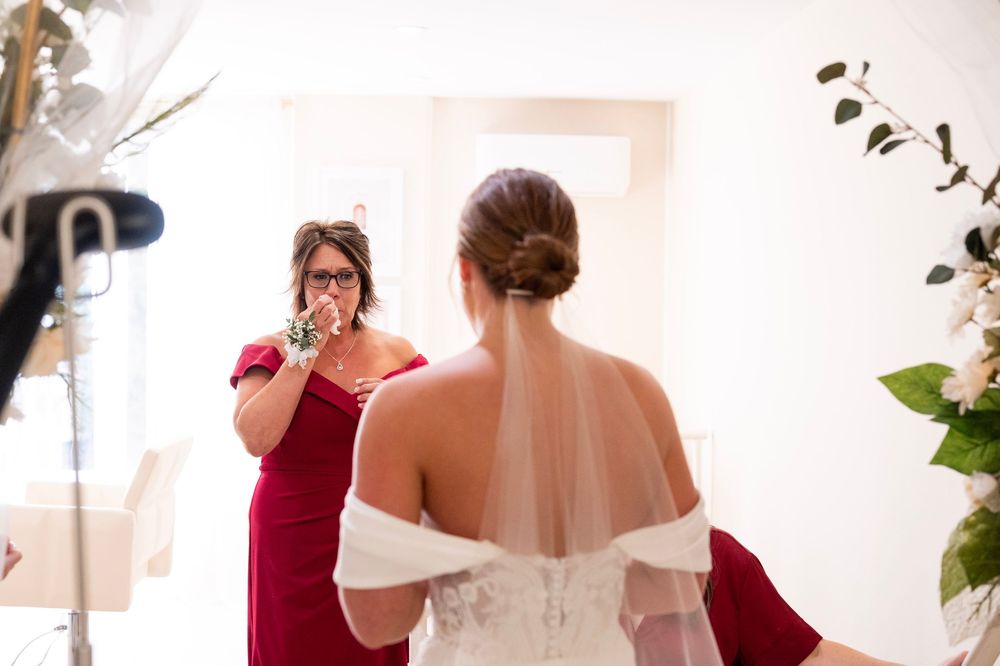 An emotional moment captured during wedding preparations in a bridal suite.