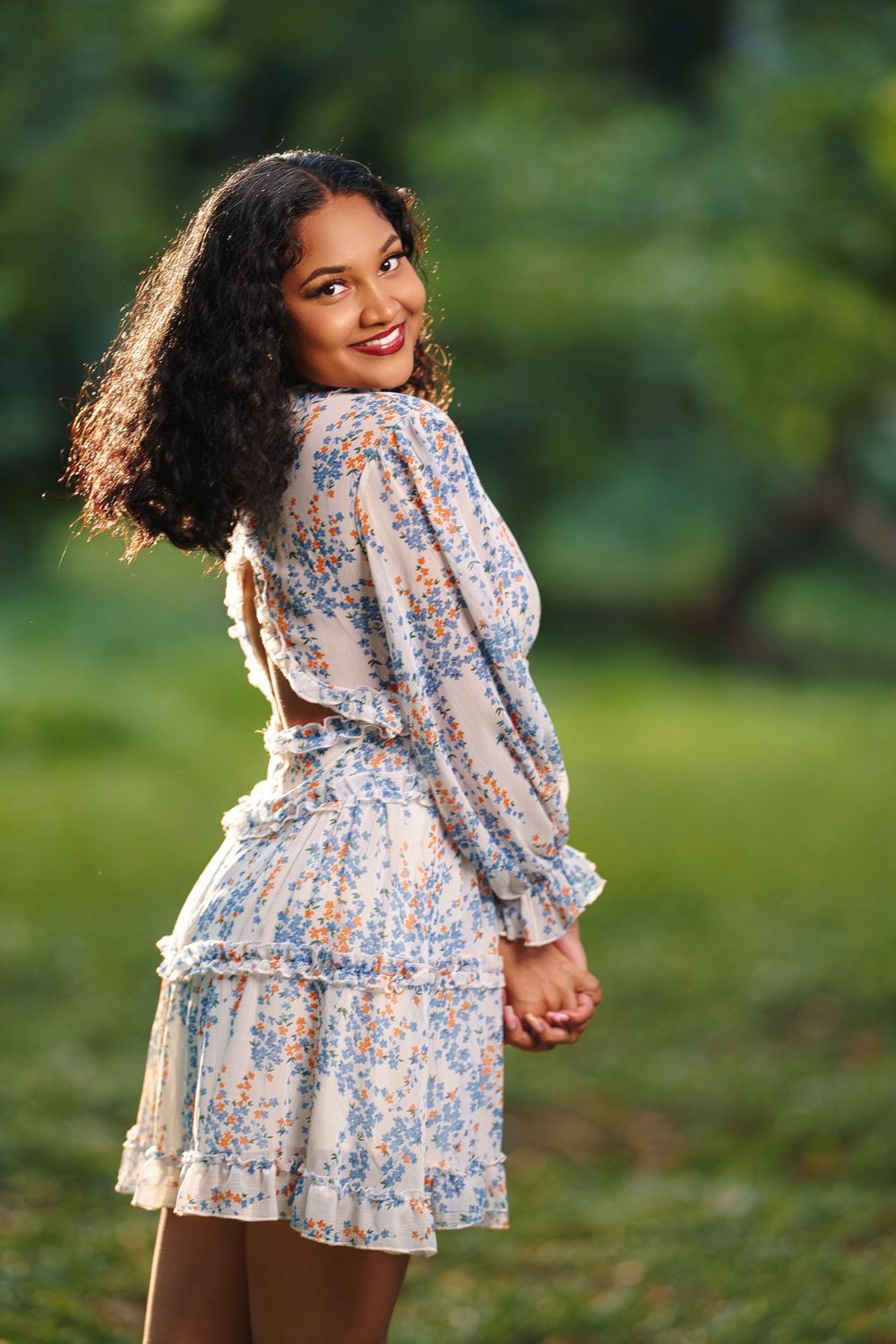 A series of outdoor photos showing someone in a floral dress with puff sleeves posing playfully in a garden setting.