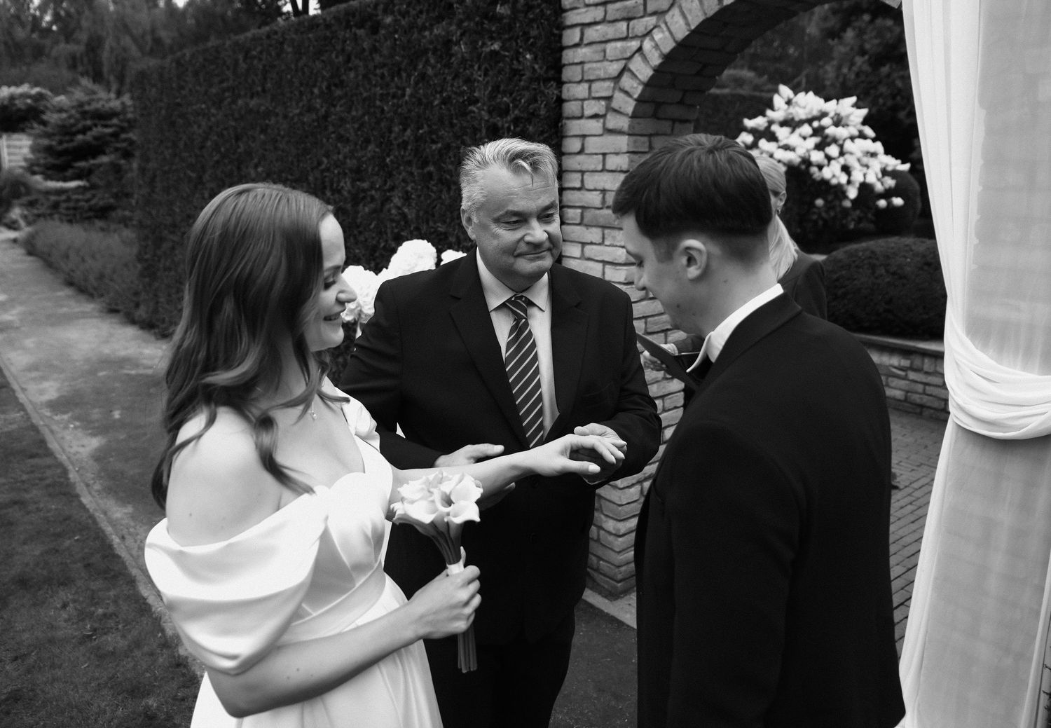 A series of black and white wedding photographs showing intimate moments between couples during their celebration.