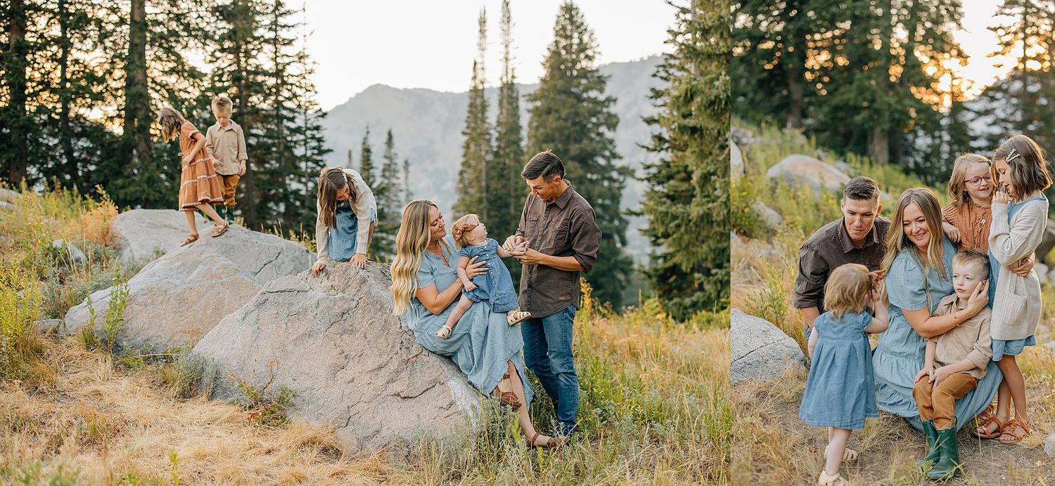 A couple shares a romantic moment among tall evergreen trees during sunset in a mountain setting.