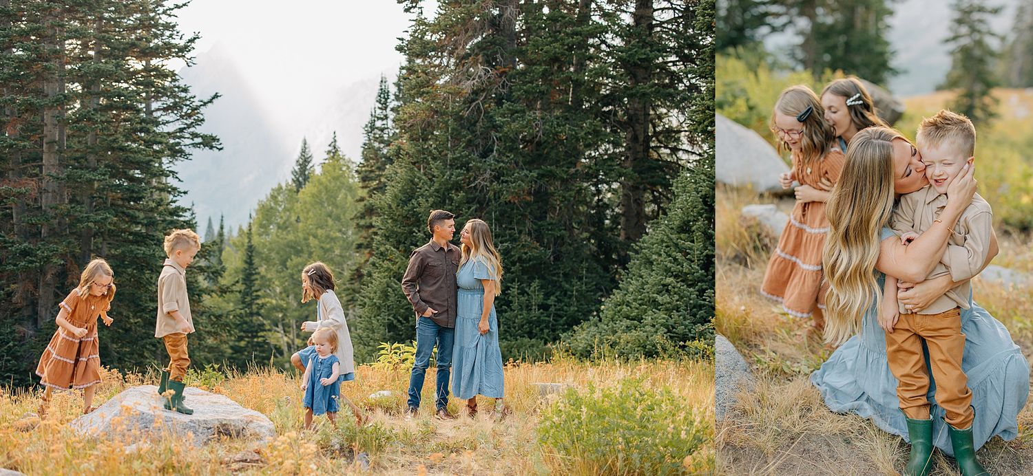 Family enjoying a scenic autumn walk together through a golden meadow with evergreen trees in the mountain landscape.