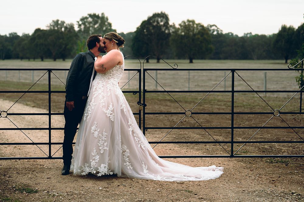 A romantic wedding photo sequence showing a couple in formal attire embracing by a rustic fence at sunset.