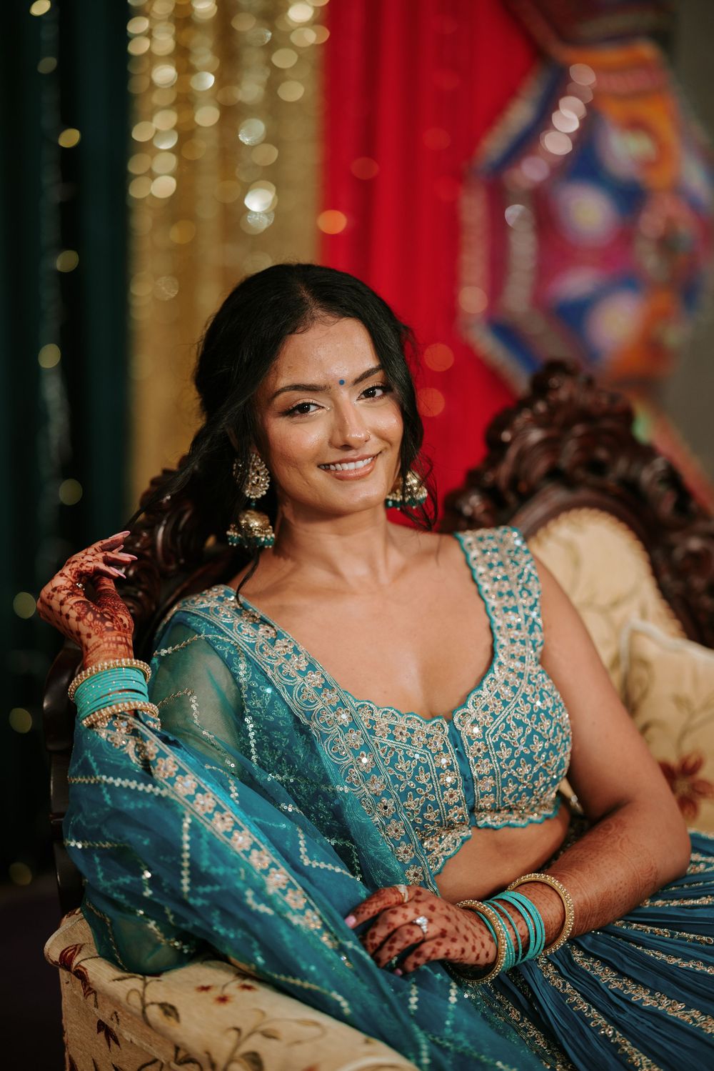 Beautiful traditional Indian bridal attire featuring a turquoise lehenga with intricate embellishments and matching jewelry.