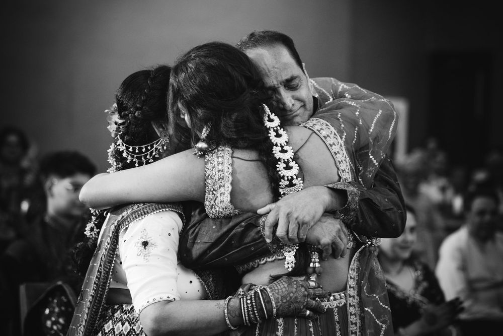 Emotional moment captured in black and white at an Indian wedding celebration.