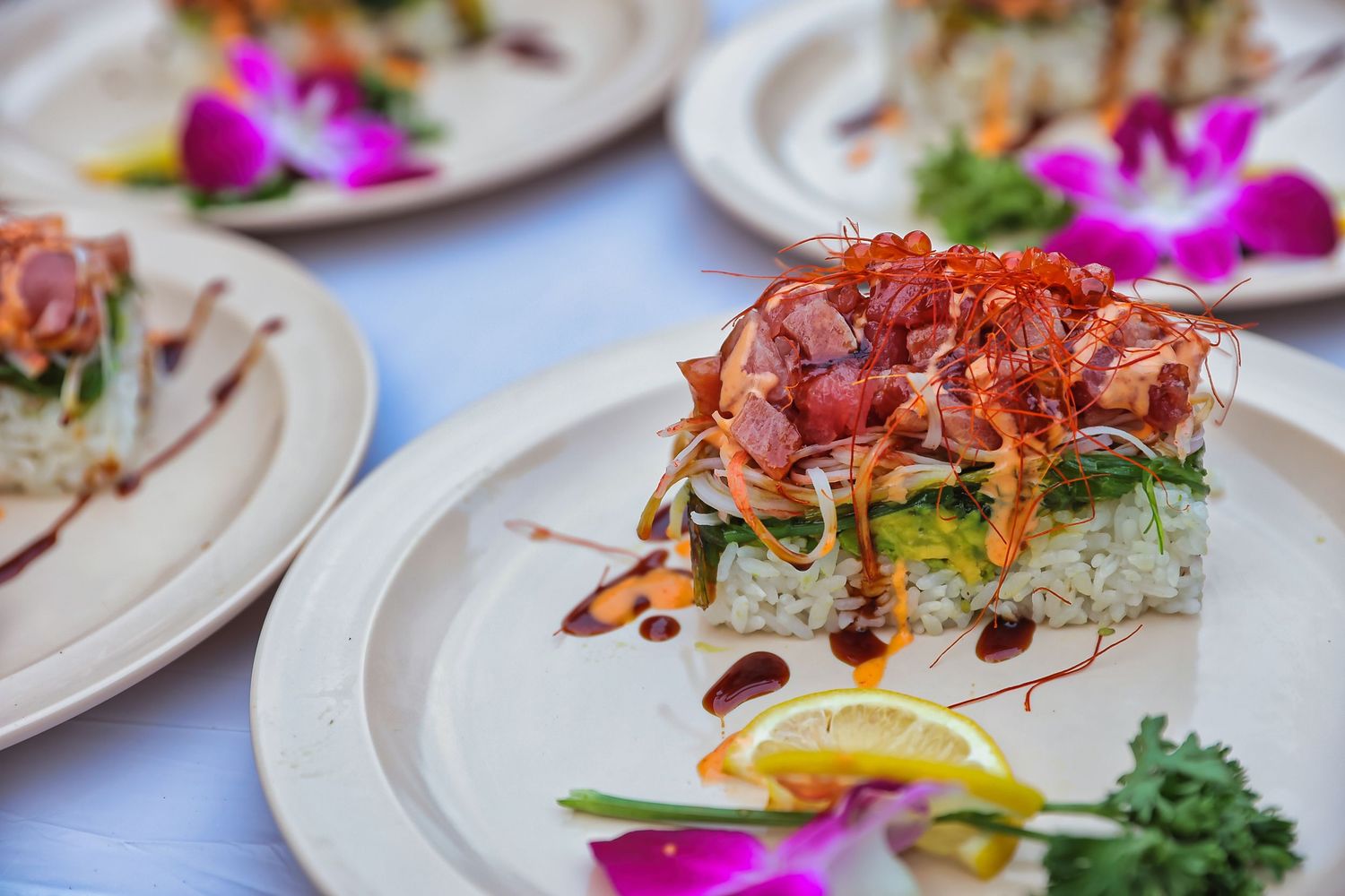 Gourmet plated dishes with edible flowers and artistic presentation.