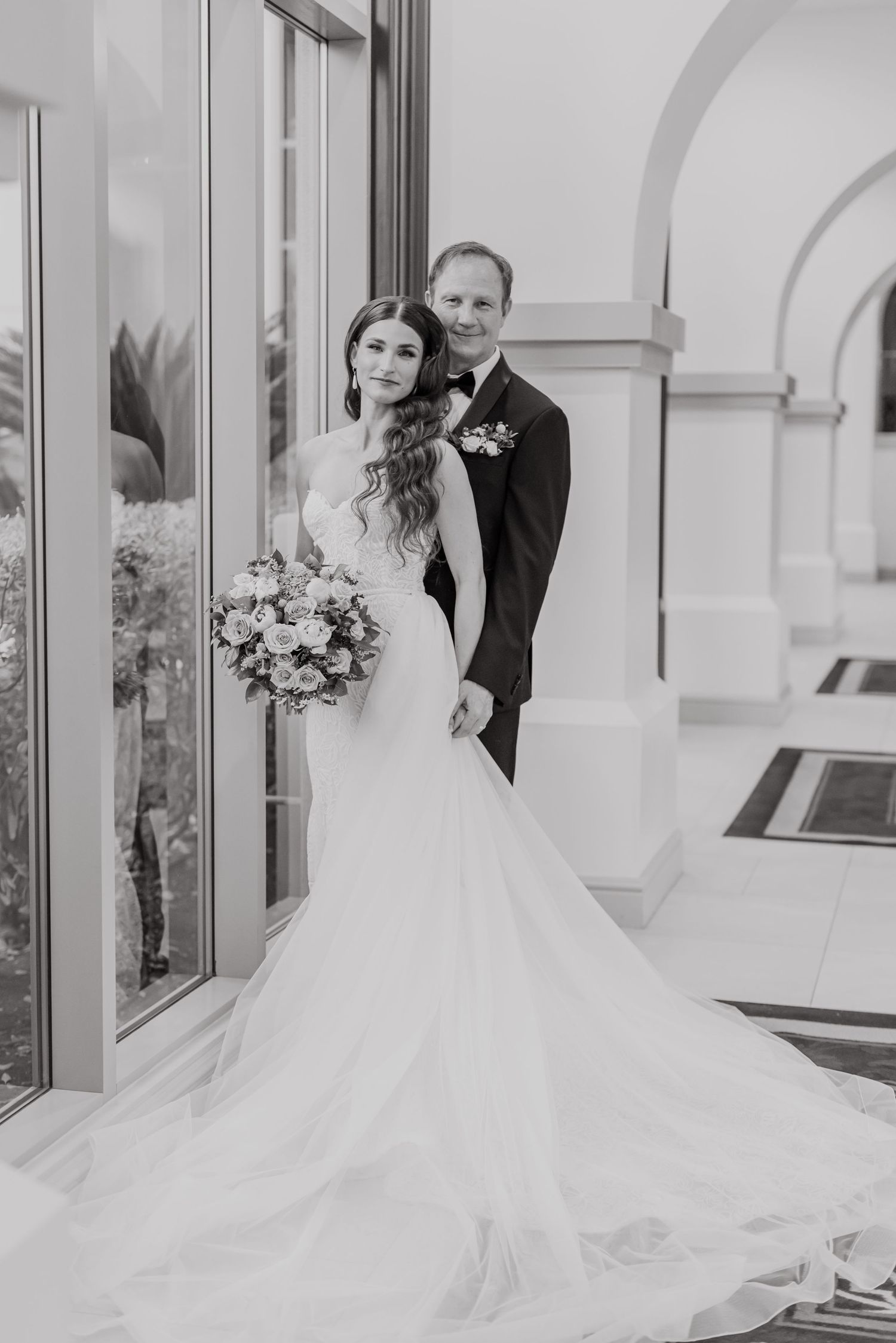 Black and white dance floor with alternating squares creates dramatic setting for wedding couple's first dance.