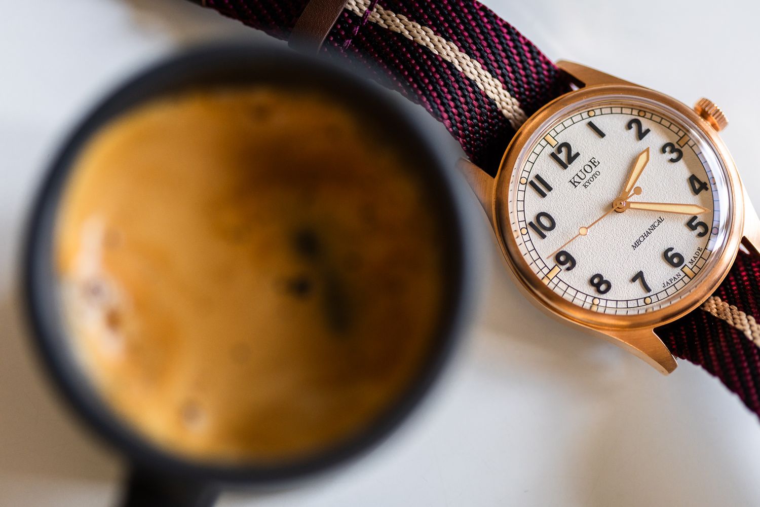A vintage pocket watch with leather strap rests on an open book with printed text.