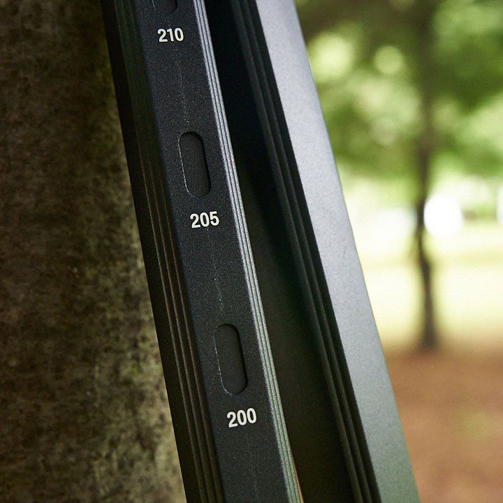 Detail shot of measurement markings 200-210 on black luggage hardware.