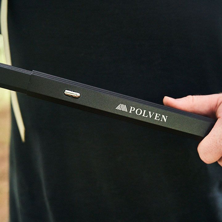 A hand holding a black Polven-branded electronic device against a dark background.
