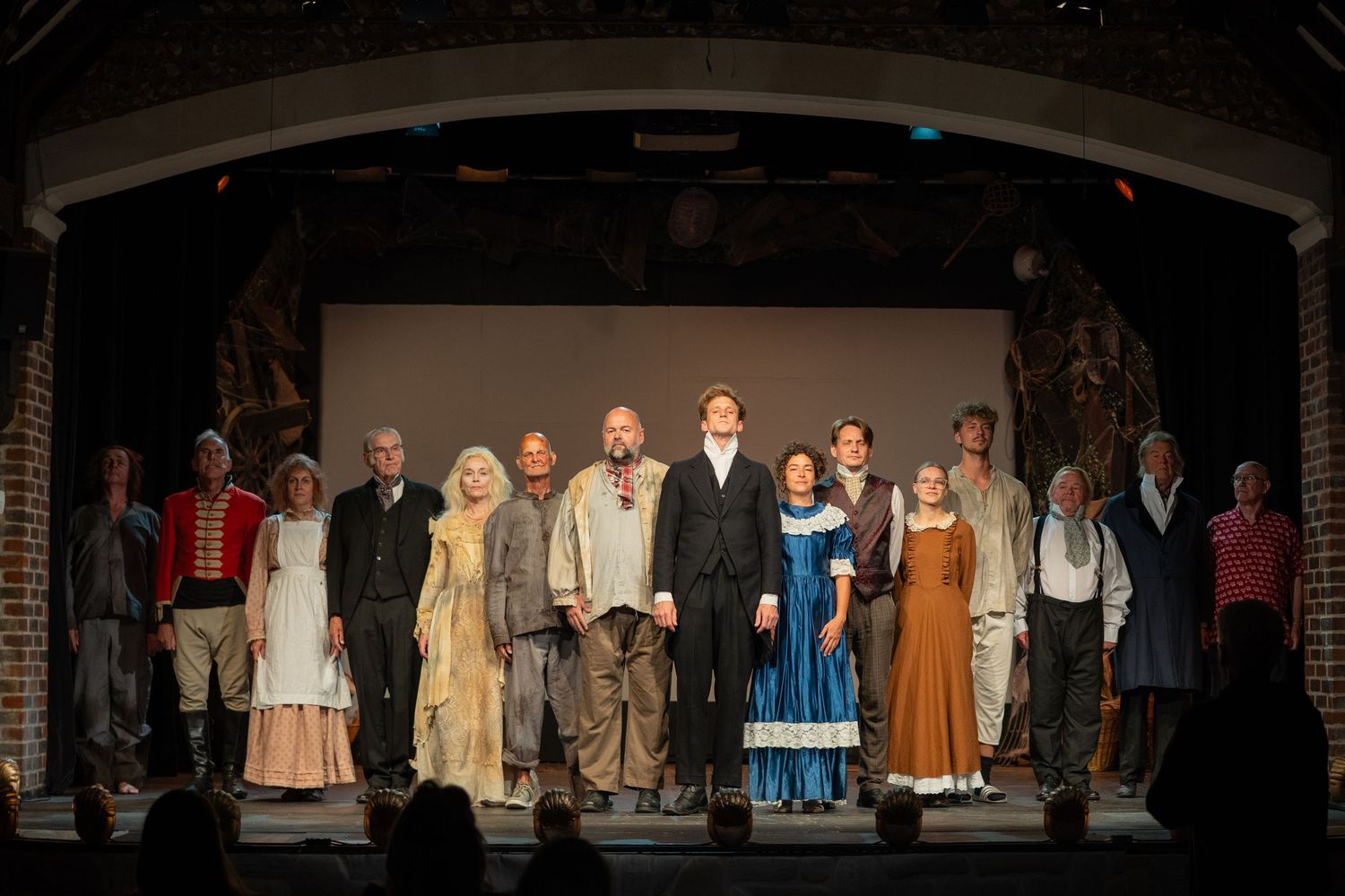 performers on stage in Brighton doing a curtain call. the actors are dressed in victorian costume for great expectations show