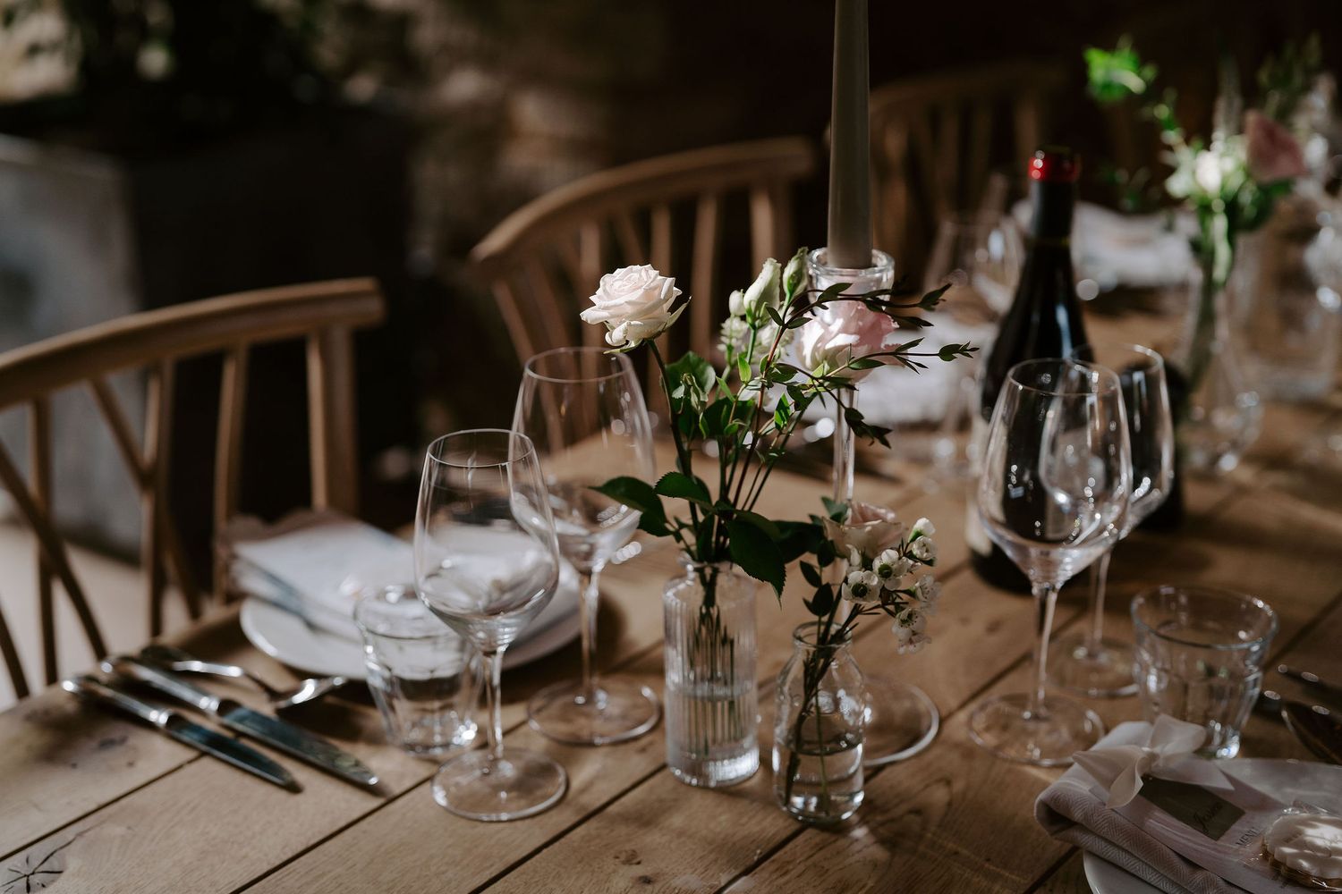 candles and flower arrangements decorating the wedding feast  barn at ivy lodge in cirencester