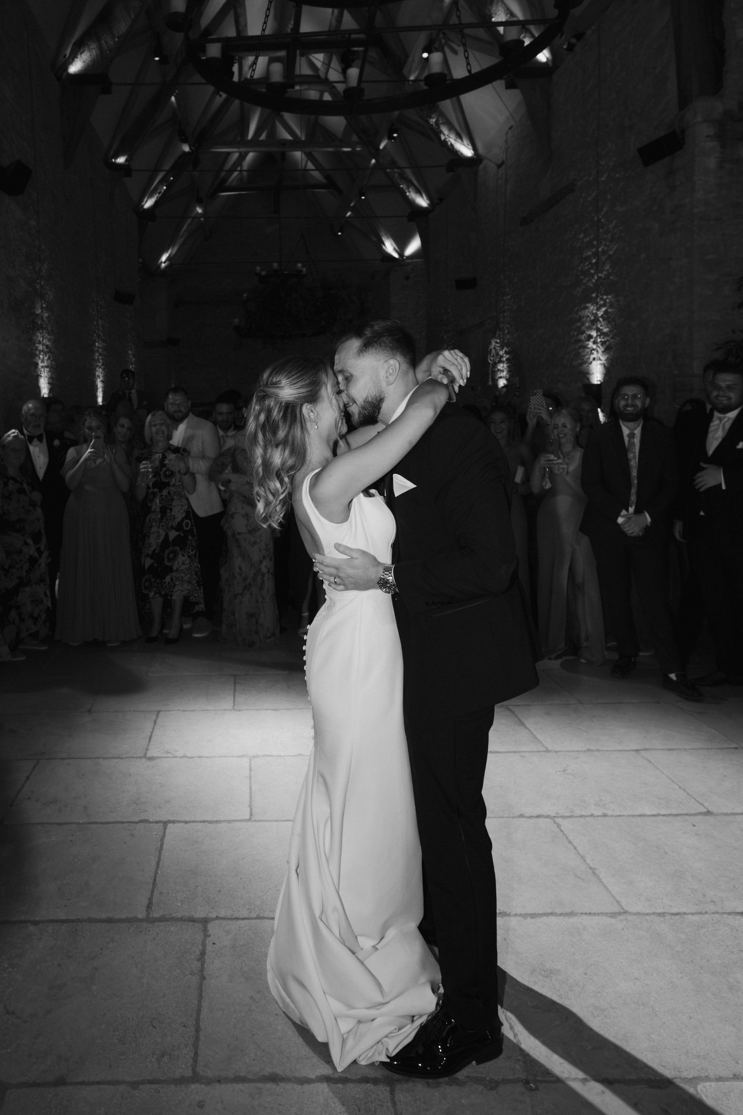bride and groom kissing during first dance at ivy lodge wedding in cirencester