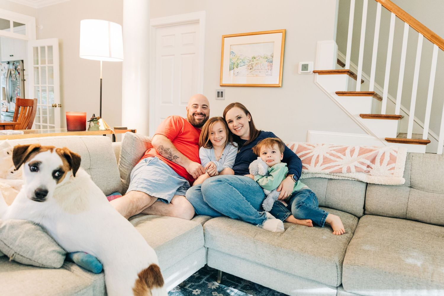 A series of photos showing people relaxing and lounging together on a comfortable gray couch in a bright living room.