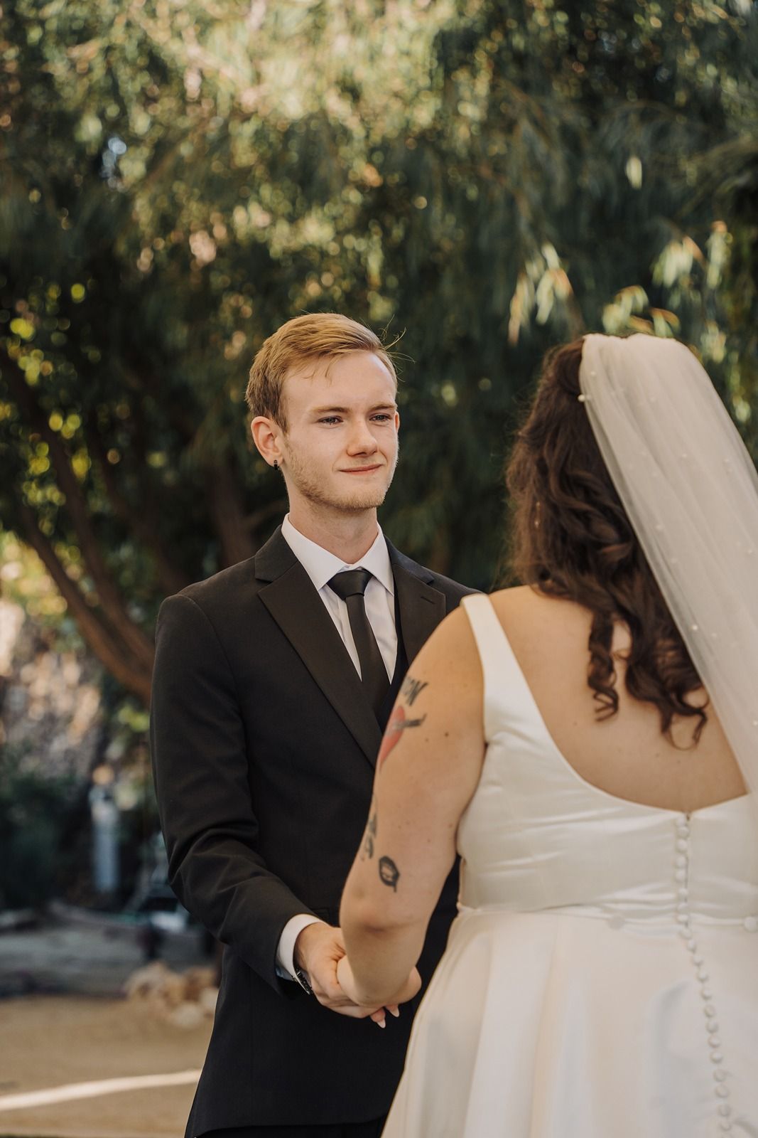 Wedding photos show couple sharing emotional moment during outdoor ceremony in natural lighting at River Garden Weddings and Events.