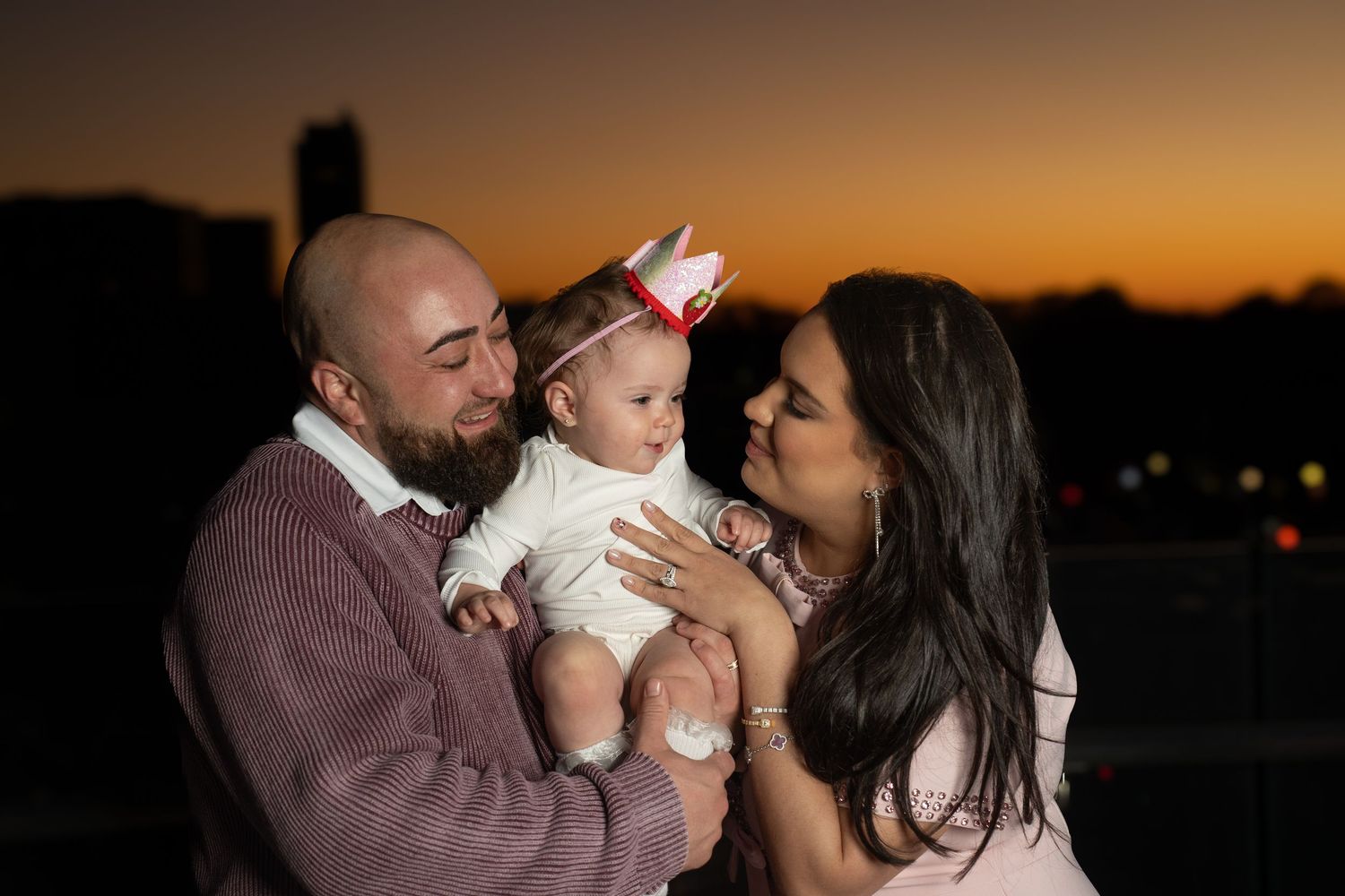 A family shares tender moments at sunset in a series of silhouetted photos.
