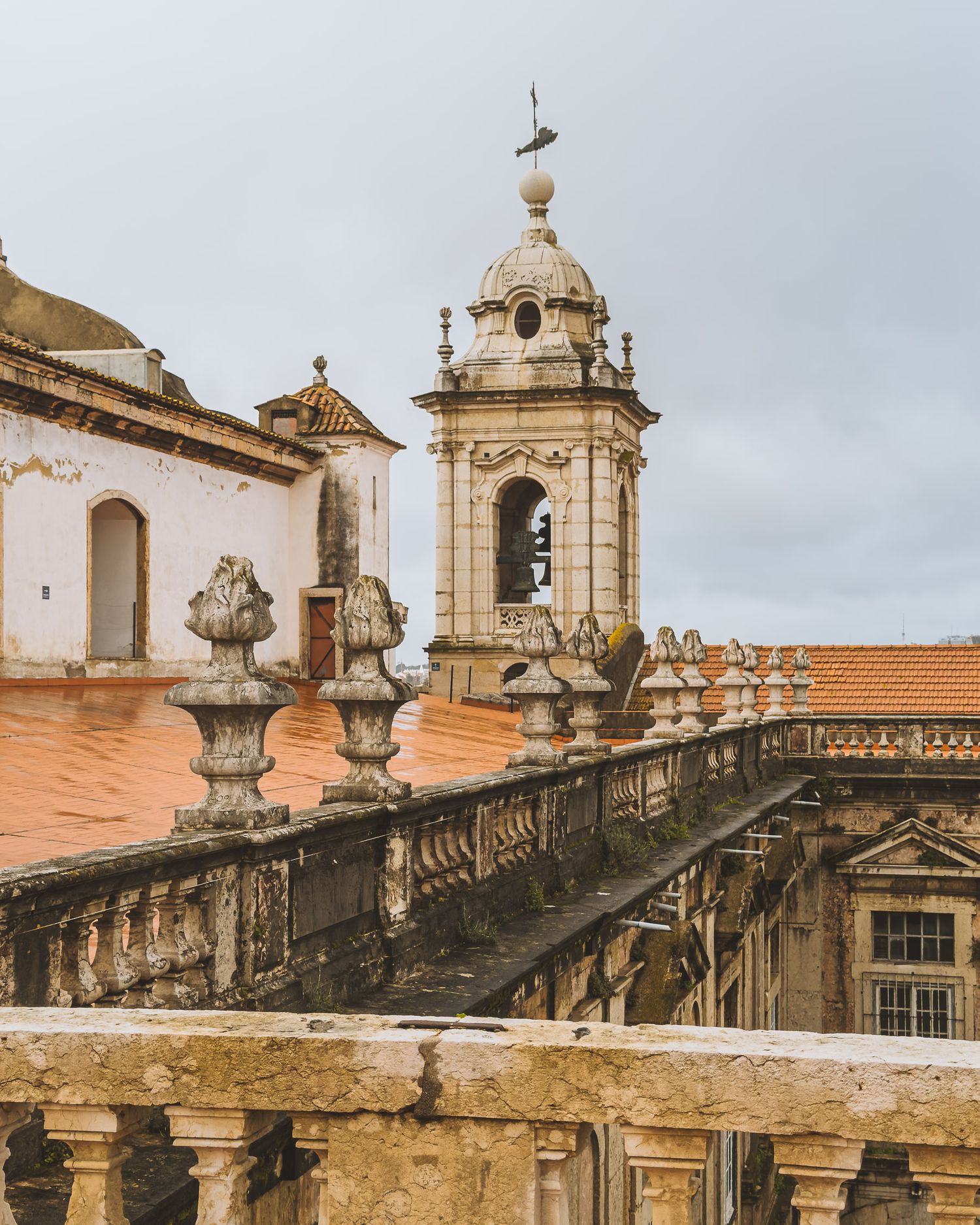 Historic Portuguese church towers and ornate architectural details against a cloudy sky.