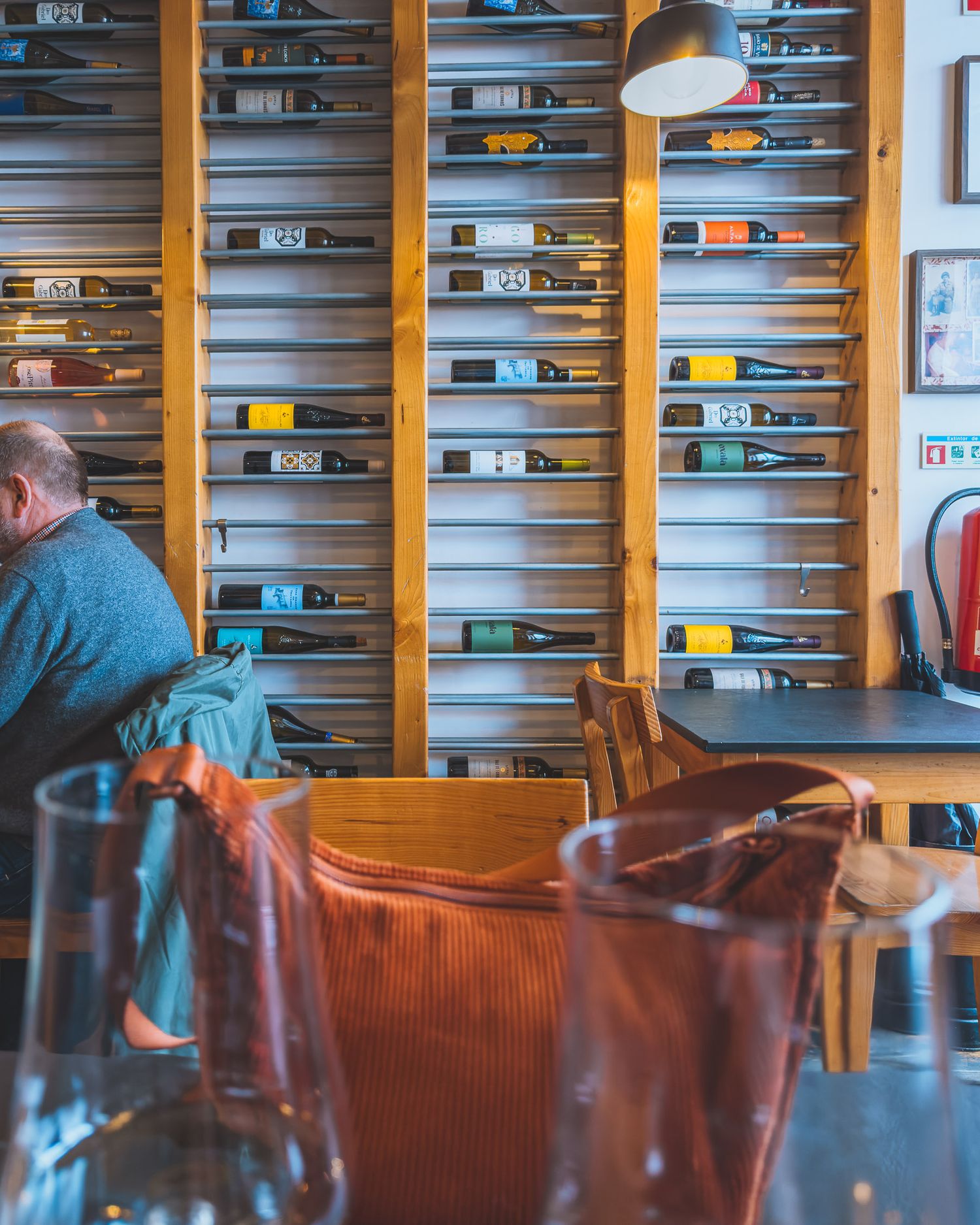 Cafe interior with wooden shelving filled with blue books and brown leather seating.