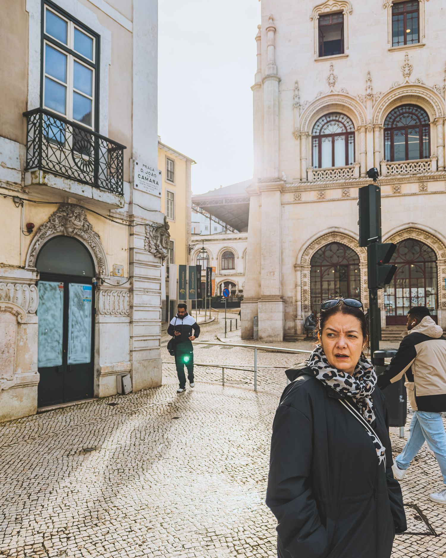 Cobblestone streets and ornate architecture in Lisbon's historic district with traditional buildings.