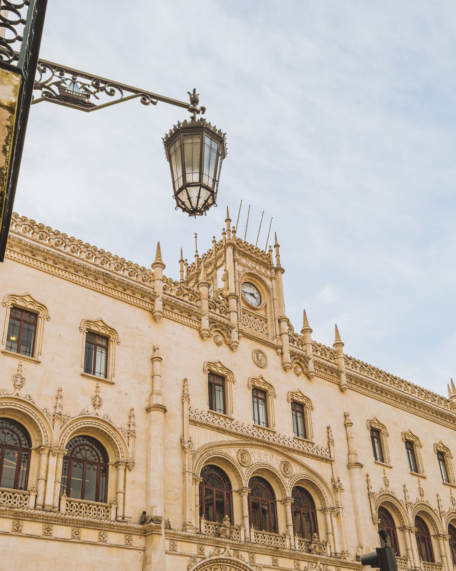 Ornate Manueline architectural details on a historic white stone building facade in Portugal.